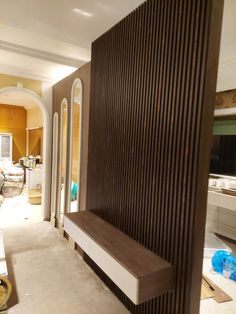 a living room filled with furniture and walls covered in wood slats