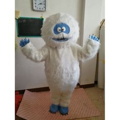 a large white monster standing on top of a rug in front of a wall with a clock