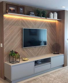 an instagram photo of a living room with a tv on the wall and shelves