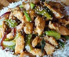 chicken and vegetable stir fry on rice with sesame seeds