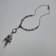 "This necklace has a vintage (non-working) Elgin watch marked 10K RGP. The watch is strung with pearl, silver, hematite and crystal beads which also dangle from the watch. The silver tone chain is dotted with faux pearls to complete the look. Given the age of the components, there will be scratches and scuffs on the watches and crystals, but I think that just adds to the vintage look...a real stunner! This necklace is 17\" long. The pendent portion is 3.5\". These necklaces make a statement and Antique Silver Beaded Jewelry Gift, Antique Silver Beaded Jewelry For Gift, Silver Metal Pearl Necklace With Beaded Chain, Vintage Wedding Necklaces With Silver Beads, Bohemian Silver Pearl Drop Jewelry, Bohemian Silver Pearl Necklace For Wedding, Victorian Silver Soldered Jewelry, Vintage Pearl Drop Pendant Jewelry, Antique Jewelry With Beaded Chain For Gifts