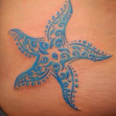 a blue bird tattoo on the back of a woman's stomach