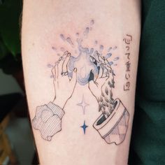 a woman's arm with a tattoo on it that has a water fountain coming out of the cup