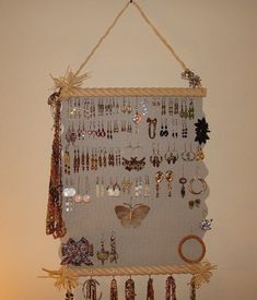 a wall mounted jewelry rack with lots of earrings on it