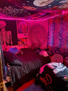 a bedroom with pink lights and skeleton decorations on the walls, along with bed linens