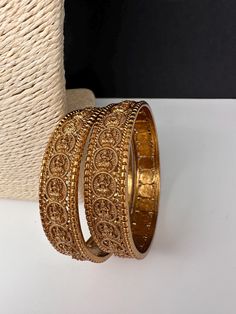 Matte Goddess Lakshmi Kassu Coin Broad Bangles Simple Gold look alike Bangles in Matte Antique Finish. It comes as a Pair (2 Bangles). Premium quality and craftmanship. Satisfaction Guaranteed. Please measure your size before ordering as we don't accept returns. Starting size we have is 2.4. We don't carry size 2.2. If you have any questions please let me know. Thank You!! Bohemian Adjustable Bangle For Diwali, Gold Bohemian Bangle For Puja, Gold Bangle For Festive Occasions, Gold Round Bracelets For Festival, Traditional Gold Bangle For Festival, Gold Bracelet For Festive Occasions, Bohemian Gold Bracelets For Puja, Bohemian Gold Jewelry For Puja, Gold Metal Jewelry For Puja