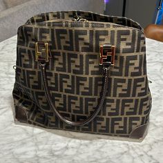 Purchased From A Local Luxury Resale Boutique In 2023. I Never Used It Like I Thought I Would. It’s A Beautiful Bag And Comes With A Strap, Dust Bag And Tie That Was Used As An Accessory For The Strap. There Is Moderate Scuffing On The Bottom Edges Of The Bag, Which I Pictured. Additionally There Are Some Snags On The Inside Of The Bag Where The Zipper Caught - Also Pictured. Poshmark Will Authenticate Anything Over $500 But I Will Also Authenticate If Requested. Smoke Free Home, Dogs Present. Pre-owned Brown Top Handle Shoulder Bag, Dog Presents, Fendi Bags, Beautiful Bags, Dust Bag, Black And Brown, My Pictures, Fendi, Bag Lady