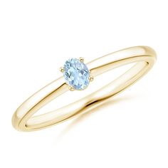 a gold ring with an oval blue topaz