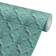 a roll of green paper with an intricate design on it