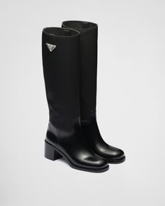 Black Brushed leather and nylon boots | PRADA Designer Black Calf Leather Knee-high Boots, Designer Black Knee-high Boots With Leather Sole, Classic Black Boots With Padded Heel, Designer Knee-high Boots With Leather Lining, Winter Luxury Boots With Rubber Heel Cap, Luxury Winter Boots With Rubber Heel Cap, Designer Calf Leather Boots With Rubber Heel Cap, Designer Boots With Reinforced Heel And Medium Fit, Designer Waterproof Boots With Round Toe