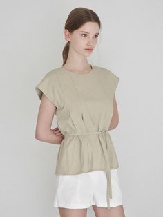 This is a trendy and feminine top by LAUATELIER that is made out of high quality and sturdy material. With distinctive mood of the design and comfortable wear, you can style it for your unique daily outfit.- Adjustable strap detail on the waist- Round neckline and hidden zipper- Casual and trendy mood Beige Fitted Sleeveless Top, Versatile Sleeveless Blouse For Everyday, Beige Cotton Tank Top For Work, Modern Sleeveless Blouse For Summer, Modern Sleeveless Summer Blouse, Fitted Beige Tank Top For Summer, Chic Beige Tank Top For Daywear, Beige Fitted Tank Top For Summer, Sleeveless Padded Blouse For Summer