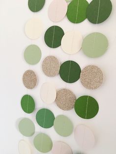 a white wall with green and beige circles hanging from it