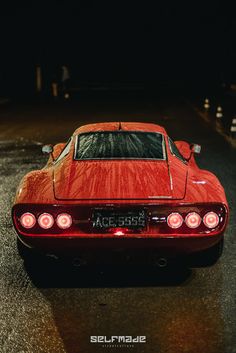 a red sports car is parked in the dark