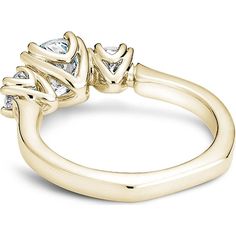 a yellow gold ring with three pear shaped diamonds