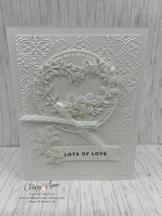 a white card with the words lots of love on it