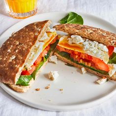 a sandwich cut in half sitting on top of a white plate