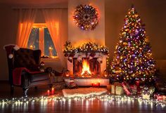 a living room decorated for christmas with lights on the fireplace and presents under the tree