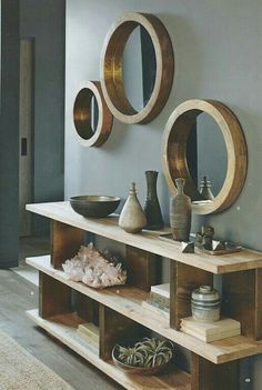 a living room filled with lots of furniture and mirrors on the wall above it's shelves