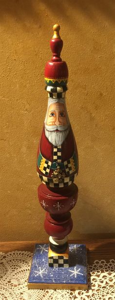 a santa clause figurine sitting on top of a table