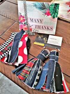 several pieces of clothing are laid out on a wooden table next to a sign that says many thanks