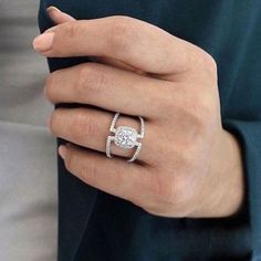 a woman's hand with a diamond ring on it