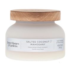 a jar of salted coconut mashagany with a wooden lid on a white background