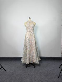 a dress on a mannequin in front of a white wall and black carpet