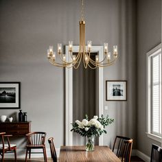 a dining room table with chairs and a chandelier