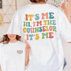 Personalized School Counselor Shirt, It's Me Hi I'm The School Counselor, Funny School Counselor Gift, Back To School Shirt Custom Counselor MATERIAL UNISEX T-SHIRT - Medium fabric (5.3 oz/yd² (180 g/m - Classic fit - Runs true to size - 100% cotton (fiber content may vary for different colors) - Tear-away label UNISEX SIZING CHART Small: Length 28" - Width 18" (4-6) Medium: Length 29" - Width 20" (6-10) Large: Length 30" - Width 22" (10-14) XL: Length 31" - Width 24" (14-18) 2XL: Length 32" - Width 26" (18-20) 3XL: Length 33" - Width 28" (20-22) All measurements are approximations. Shirts may be within 1" of the dimensions listed The shirts were measured laying on a flat surface, side to side and top to bottom. HOW TO PLACE ORDER: 1-) Please, Check and Review all Photos. 2-) Select Your S School Counselor Shirt, School Counselor Gifts, Counselor Gifts, Funny School, School Counselor, School Humor, School Shirts, I School, Flat Surface