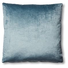 a blue velvet pillow on a white background