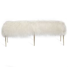 a white bench with long legs and fur on it