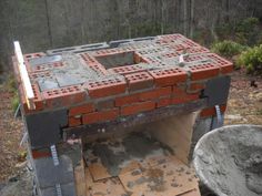 an old brick oven is being built in the woods