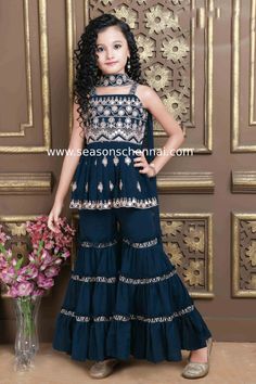 Ideal to style this party wear for your little girl more adorable by opting this peacock blue sharara suit. This elegantly fabricated of georgette is beautified with sequins and embroidery work all over the kurta. This beautiful kurta is paired elegantly with a flared sharara pant. A matching georgette dupatta and size 18 to 26 - sleeveless & Size 28 to 38 3/4th georgette sleeves completes the ensemble perfectly. Girls Sharara Suit Design Kids, Baby Girl Sarara Dress, Sharara For Kids, Kids Sharara Designs, Sarara Dress, Girls Ethnic Wear, Flared Sharara, Blue Sharara