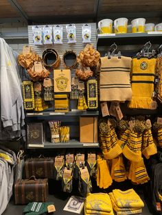 a store display with yellow and black items on it's shelves, along with harry potter merchandise