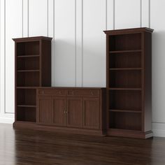 two black bookcases on top of each other in front of a white wall