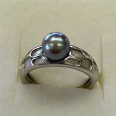 Brand New And Never Worn. Unique Design With Rough Crevices And Shiny Finish. Ring Is A Nice Weight And Solid. All Solid 14kt White Gold. Genuine Cultured Pearl Has Been Treated To A Grey Color. 7 Mm Pearl. Ring Size 6.5.Ring Can Be Sized By Your Jeweler. Shank At Bottom Is 3mm Width. Gold Weight Is 4.2 Grams. Elegant White Gold Pearl Ring With Bezel Setting, Elegant Oval Pearl Ring With Bezel Setting, Formal Pearl Ring With Bezel Setting, Elegant Silver Platinum Pearl Ring, Silver Hallmarked Round Cut Pearl Ring, Classic Platinum Pearl Ring For Gift, Classic Platinum Pearl Ring As Gift, Elegant Pearl Ring With Bezel Setting For Formal Occasions, Elegant Pearl Ring With Bezel Setting For Formal Events