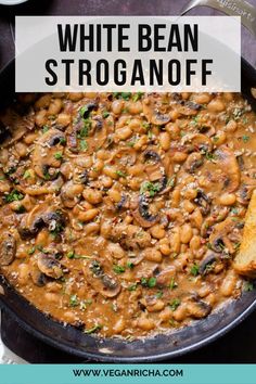 a skillet filled with white bean stroganoni and parmesan bread