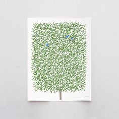 a green tree with two blue birds sitting on it's branches in front of a white wall