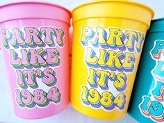 three brightly colored plastic cups with the words party like it's 1994 on them