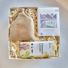 an open box containing soaps, toothpaste and handmade sachet in it