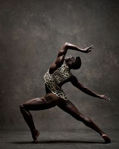 a man in a leotard and leopard print shirt is doing a dance move