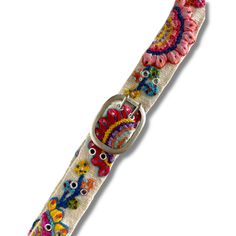 A Peruvian style staple meticulously crafted by hand, this embroidered wool belt features elaborate floral embroidery in mystifying colors, pressed studs and a silver metal buckle. Imported. Exclusive. Sizes: Small fits waist of 24-32", Medium fits waist of 28-36", Large fits waist of 34-42", XL fits waist of 38-46". Approx. 1-7/8" Wide. Color: Off white. Mac Saturn, Peruvian Style, Embroidered Wool, Press Studs, Metal Buckles, Floral Embroidery, Metallic Silver, Mac, Buckle