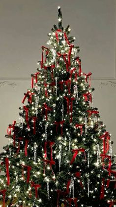 a decorated christmas tree with red bows and lights