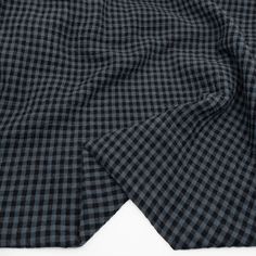 the black and white checkered fabric is folded on top of each other, with one piece