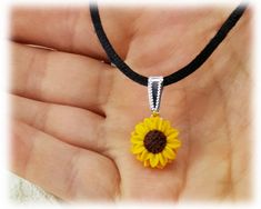 "Petite Sunflower Choker. This handcrafted sunflower necklace is featured on a black satin cord with an adjustable extender. -Sunflower diameter : about 15mm -Choose Black Cord Collar or Choker Length -1.5\" extender -Silver plated components Flowers are hand sculpted without molds or paint using polymer clay, a durable water-resistant material. Shop: StrandedTreasures.etsy.com" Adjustable Yellow Flower Pendant Necklace, Yellow Adjustable Flower Pendant Necklace, Adjustable Yellow Flower Charm Necklace, Himawari Uzumaki, Cord Choker, Small Sunflower, Sunflower Jewelry, Sunflower Necklace, Flower Choker