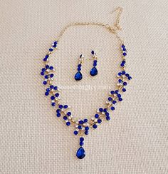 "❤Shop with us online at - https://SomethingIvy.com/❤ Matching Set - Sapphire Blue Necklace and Earrings - Royal Blue Necklace - Midnight Blue Necklace - Navy Blue Necklace and Earrings Available in bulk for bridal parties, groups, event and gifts Earrings Size: 1.5\" Long Entire Necklace Size end to end: 19\" Long Embellishment Size only: 10.5\" Adjustable size Matching bracelet available" Blue Dangle Necklaces For Party, Blue Dangle Jewelry For Party, Blue Crystal Jewelry With Matching Earrings, Blue Dangle Party Jewelry, Blue Crystal Necklace In Costume Jewelry Style, Blue Crystal Jewelry Sets For Gifts, Elegant Blue Dangle Jewelry Sets, Blue Crystal Necklace Costume Jewelry, Blue Crystal Costume Jewelry Necklace