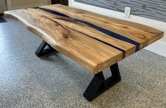 a wooden bench sitting on top of a floor next to a wall in a room