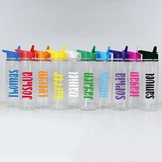 six personalized water bottles with the names of different colors and designs are lined up in a row