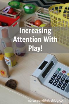 a toy calculator sitting on top of a wooden table next to other toys