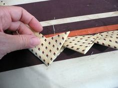 a person is cutting fabric with scissors on a table